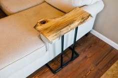 a wooden table sitting on top of a white couch