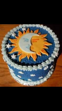 a blue and white cake with the sun on it