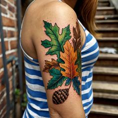 a woman with a tattoo on her arm has an oak leaf and acorn