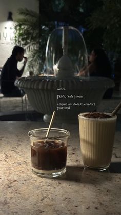 two drinks sitting on top of a table next to each other