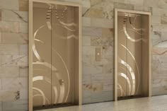 three doors with decorative designs on them in a room that has marble walls and flooring