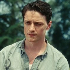 a man in a green shirt looking at the camera