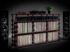 an old record player stands next to a shelf full of records