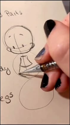 someone is drawing a cartoon character on paper with a pen and inking it out