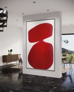 an abstract painting hangs in the middle of a room