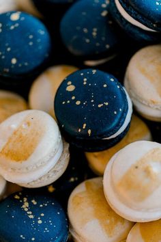 several blue and white macaroons with gold flecks