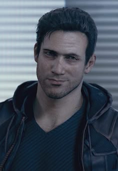 a close up of a person wearing a jacket and looking at the camera with a serious look on his face