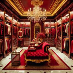 a red couch sitting in front of a closet filled with clothes