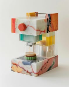 a multicolored object is sitting on top of a white surface and it looks like something out of space