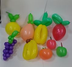 balloons and fruit are arranged on the floor