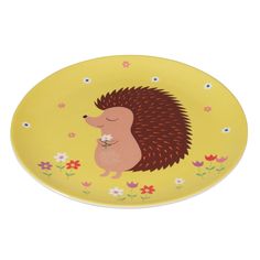 a yellow plate with a cartoon hedge holding a flower in it's mouth on a white background