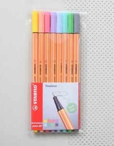 four different colored pens are in the package