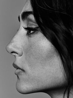 a black and white photo of a woman's profile with her eyes closed to the side