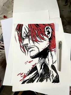 a drawing of a man with red hair and glasses on top of paper next to a pen