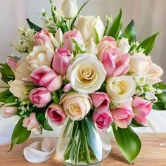 a vase filled with lots of pink and white flowers