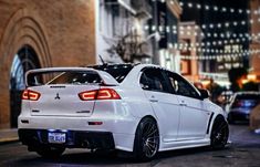 a white car is parked on the street