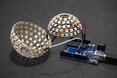 an electronic device that is connected to a light bulb with wires and circuit board attached