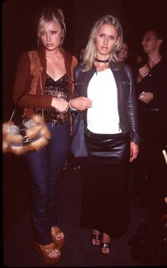 two women standing next to each other at a party