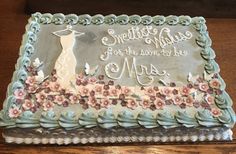 a sheet cake with frosting and flowers on it