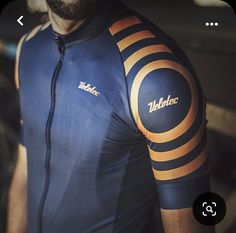 a man wearing a blue and orange bike jersey