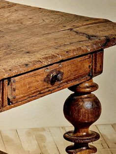 an old wooden table with two drawers on it