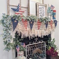 a fireplace decorated with american flags and greenery