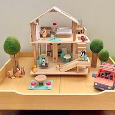 a doll house with furniture and accessories on a table