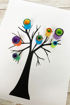 an art project for kids to make with toilet rolls and paper roll birds on a tree