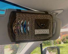 there are many different items in the back seat of a car that is filled with plates and cups