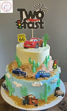 a two tier cake with cars on it