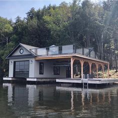 a boat dock with a house on the water