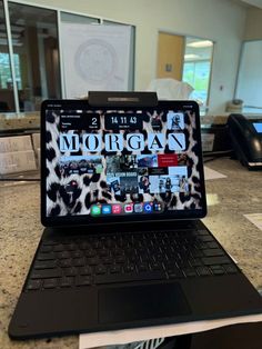 an open laptop computer sitting on top of a table