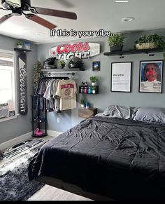a bed sitting in a bedroom next to a window with pictures on the wall above it
