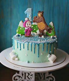 a birthday cake decorated with frosting and animals
