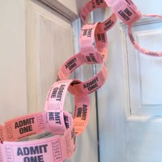 some pink tape is attached to a door with the words admit one printed on it
