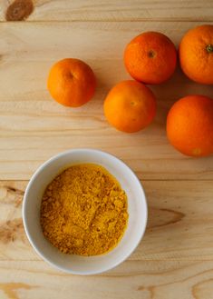 oranges and powder in a bowl on a wooden table