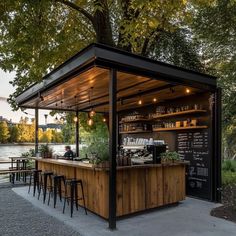 an outdoor bar with wooden tables and stools