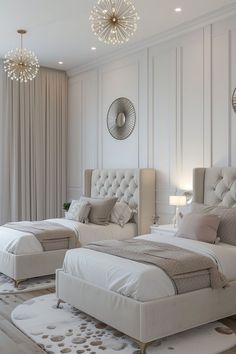 two white beds sitting next to each other on top of a rug in a bedroom