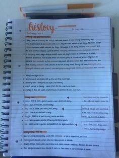 a notebook with the words history written in orange and black on it next to a pencil