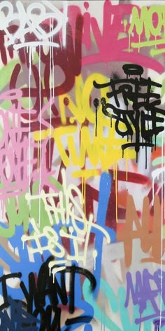 graffiti on the side of a wall with different colors and sizes, including black letters
