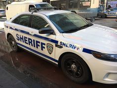 a police car is parked on the side of the street