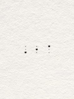 three black dots are on the white paper