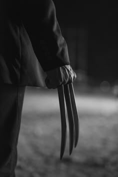 black and white photograph of a person holding an animal's claws