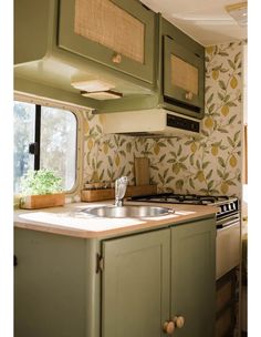 a kitchen area with sink, stove and window