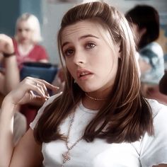 a young woman sitting in front of a group of people