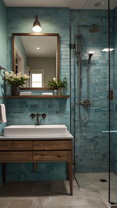 a bathroom with blue tile walls and flooring, including a wooden sink countertop