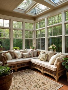 a sun room with lots of windows and furniture
