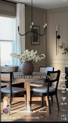 an image of a dining room with flowers in the vase on the dinning table