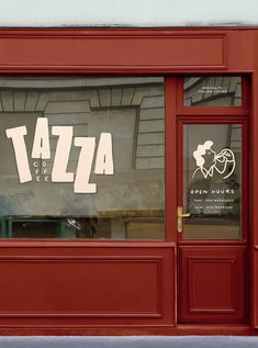 there is a sign that says tazza coffee on the window