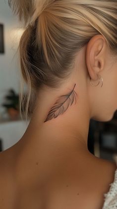 a woman with a feather tattoo on her neck